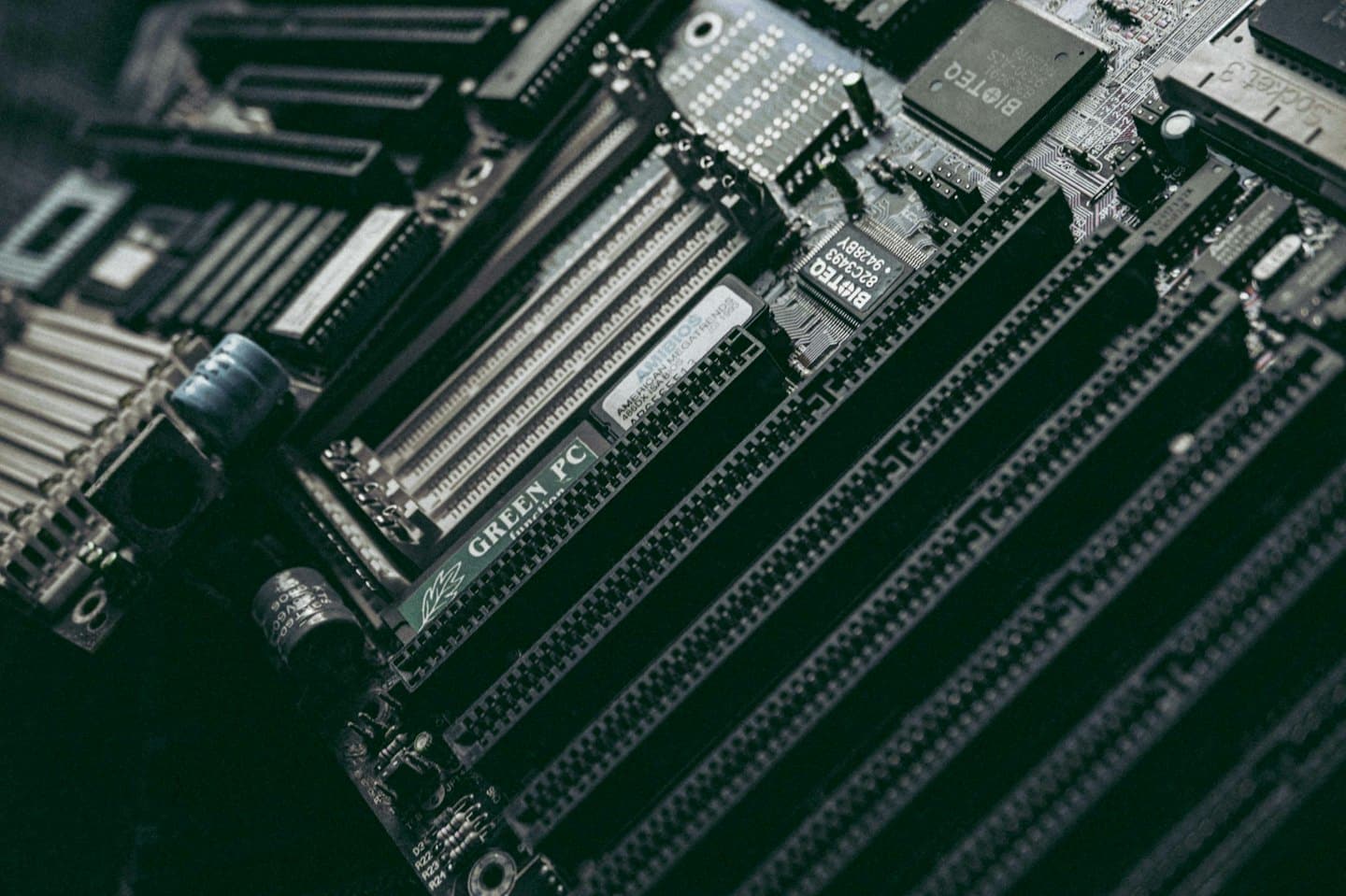 Close-up of a computer motherboard with visible chips and slots.