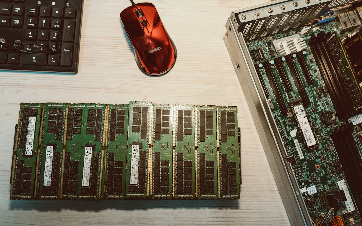 Computer hardware components arranged on a wooden desk.